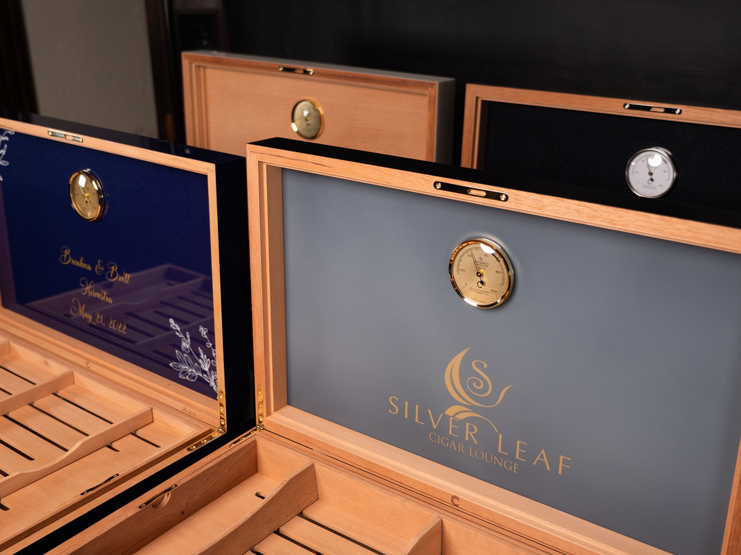 The underside of a humidor lid, coating even, hardware set on the optical line.