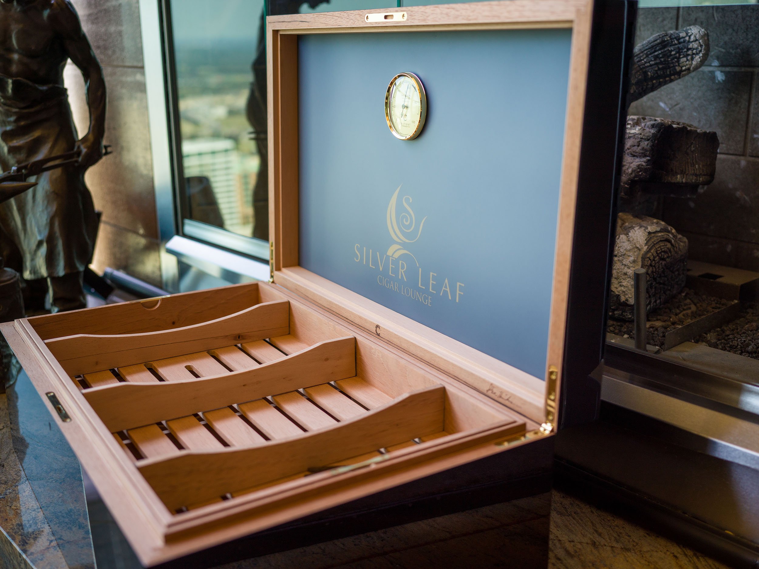 A closed dark humidor in a quiet room, made to be used.